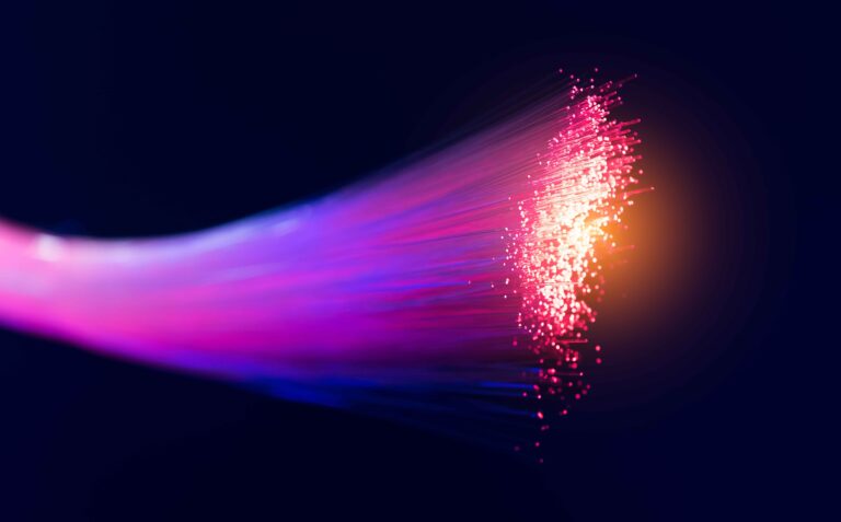 Abstract picture of pink fibre optic cables against black background