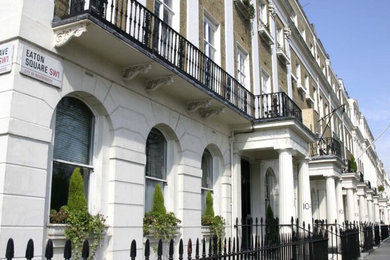 Angled shot of white stucco-fronted houses in Eaton Square in the Belgravia district of London