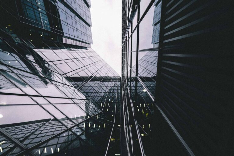 Worm's eye view of high-rise glass buildings in London with dark contrast