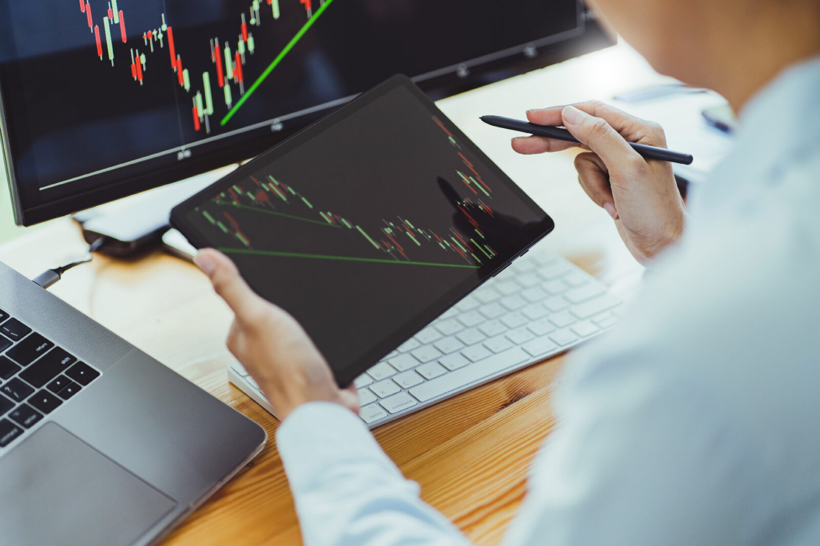 Concept picture of investor calculating a valuation of stock market exchange on an ipad