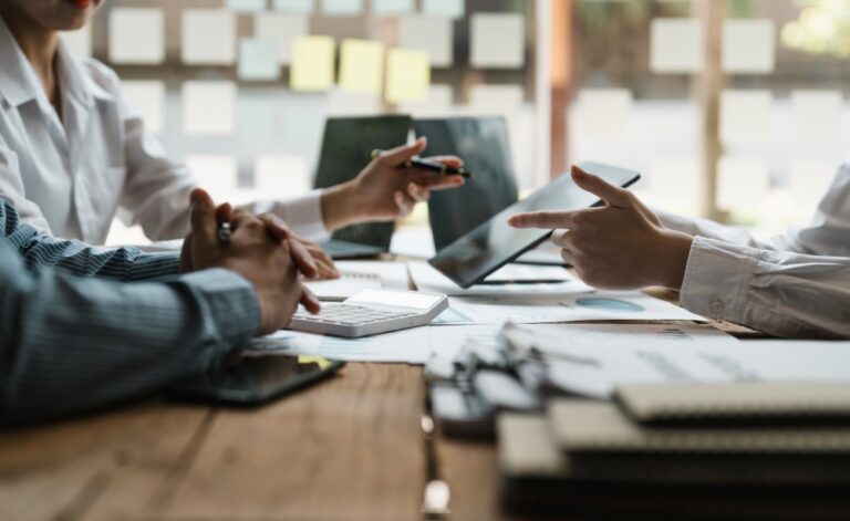 Business people meeting to plan business strategies around table